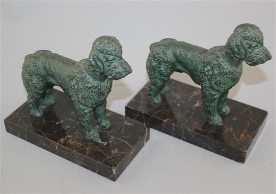 A pair of French Art Deco patinated metal bookends, modelled as poodles, 6in.